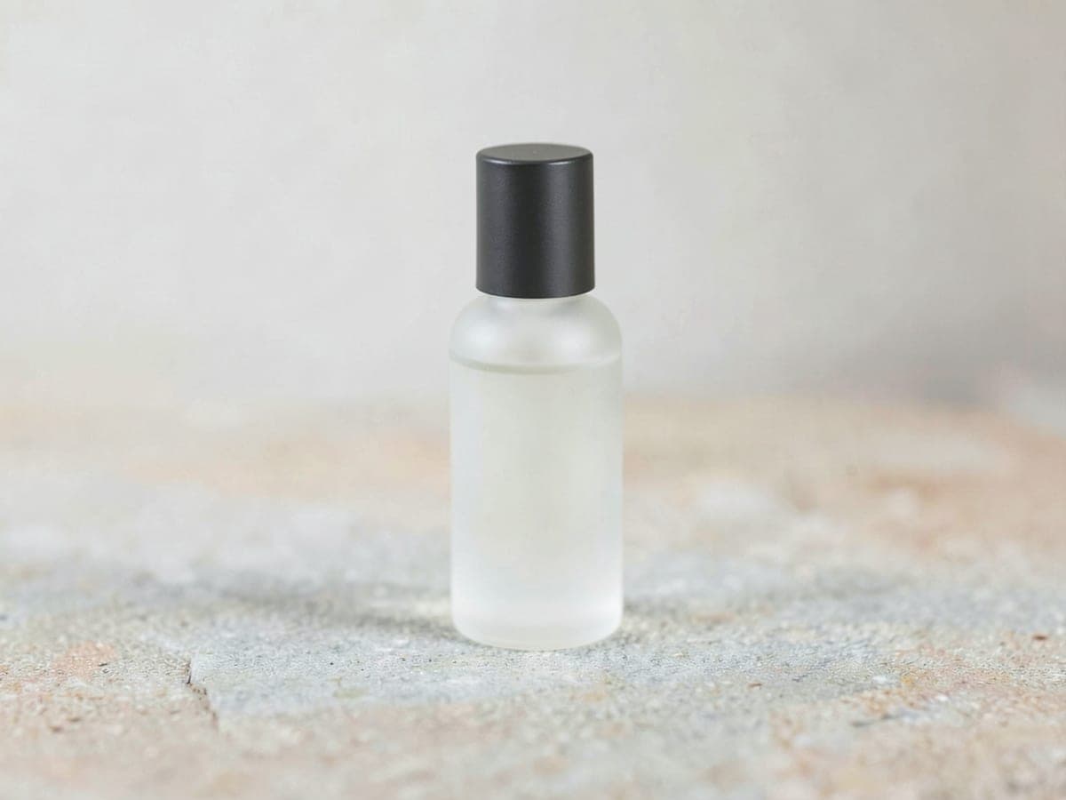 Serum bottle on stone, flat light